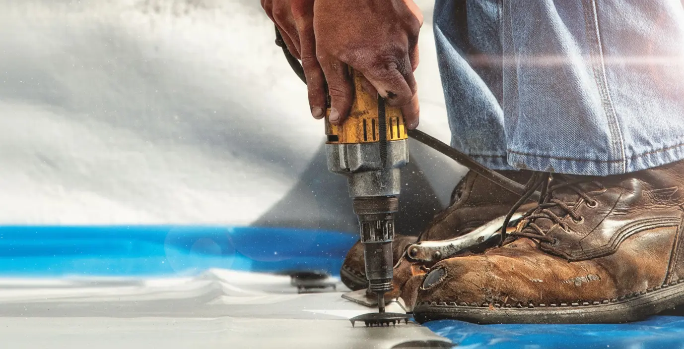 Tru-Kote technician working with power drill on roofing project